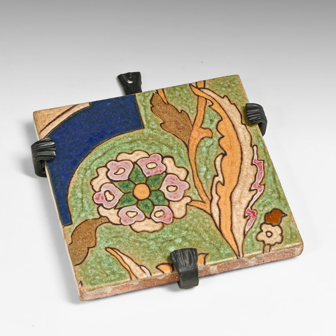 Malibu Potteries Arts & Crafts Cuenca Tile c1926-1932: Malibu Potteries Arts & Crafts Cuenca Tile c1926-1932. Marked DE 824. Tiny flea bite to corner, otherwise perfect condition. Custom-fitted four-prong wrought-iron trivet presentation frame by Bushere
