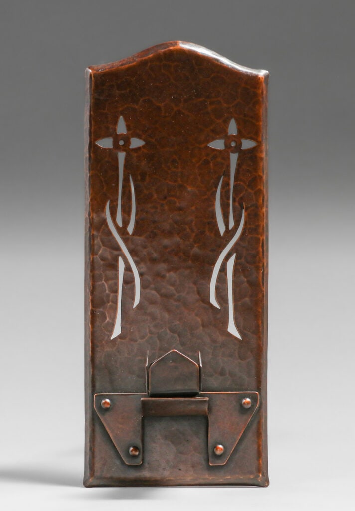 The Copper Shop, Oakland, CA Cutout Candle Sconce c1913-1915: The Copper Shop , Oakland, CA ( Bessie Whitaker & Jane Brandon ) hammered copper candle sconce with cutout floral motif. The stylized grass blades are done almost exactly the was Ernest Burnley did
