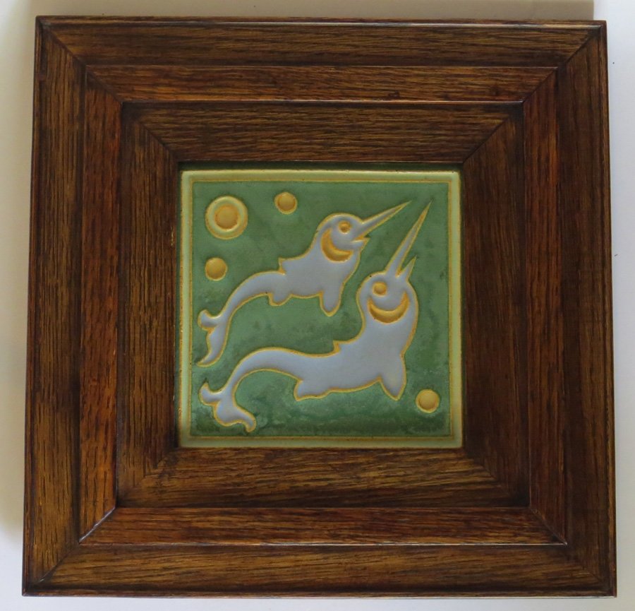Wheatley Framed Double Dolphin Tile: Wheatley Pottery matte green tile with two stylized dolphins in a nice oak frame. Unsigned except the typical three incised lines used by Wheatley. Tile 6" x 6". Oak frame 12" x 12". Shipping: We box