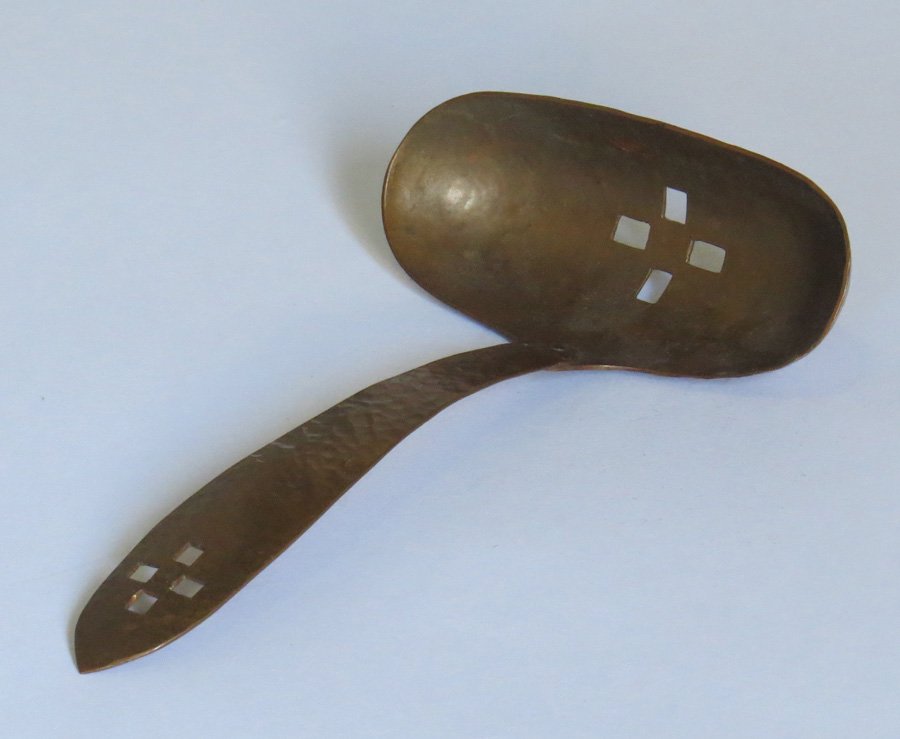 Minneapolis Handicraft Guild Cutout Spoon: Hammered copper cutout spoon attributed to Minneapolis Handicraft Guild. Unsigned. 7". Shipping: We box and ship ourselves, to keep shipping costs low. We do not use a packaging service, unless the cu