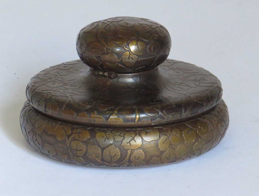 Marshall Fields Brass Inkwell: Marshall Fields brass inkwell with acid-etched design. Impressed "MF & Co Art Metal Craft" on bottom. 3"h x 4.5"d.