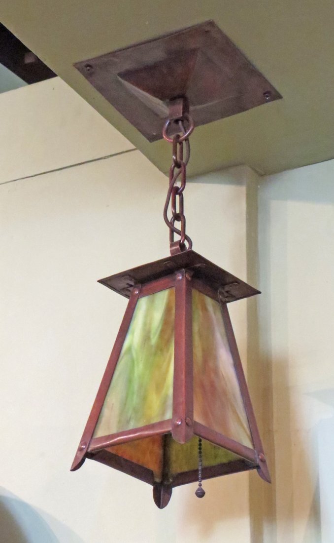 Pr Hammered Copper Pendant Sconces: Pr hammered copper pendant scones similar to Gustav Stickley. Unsigned. 17" overall height. Ceiling plates are 6.5"square. Lanterns 7.5"h x 5.25"sq.