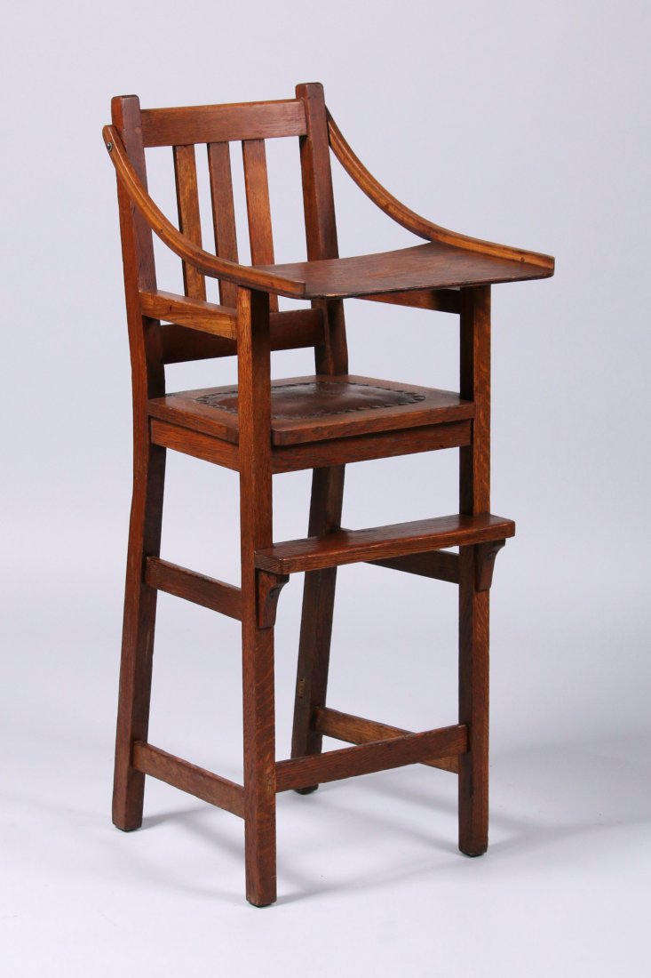 Limbert Highchair: Limbert highchair. Excellent original finish and original leather. Lower rear cross slat missing. Signed with branded mark. Tray replaced years ago. 39"h x 16"w x 20"d. This lot is being sold to benef