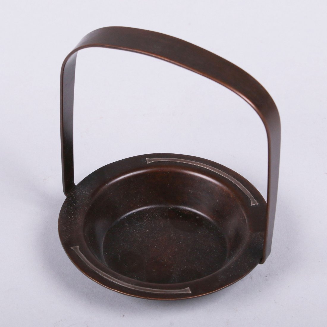 Silvercrest Sterling on Bronze Ashtray: Small Silvercrest one-handled sterling on bronze ashtray #432. Signed. Original patina. 4.5"h x 3 5/8"d. This lot is being sold to benefit The Dirk van Erp Foundation. We box and ship ourselves, to ke