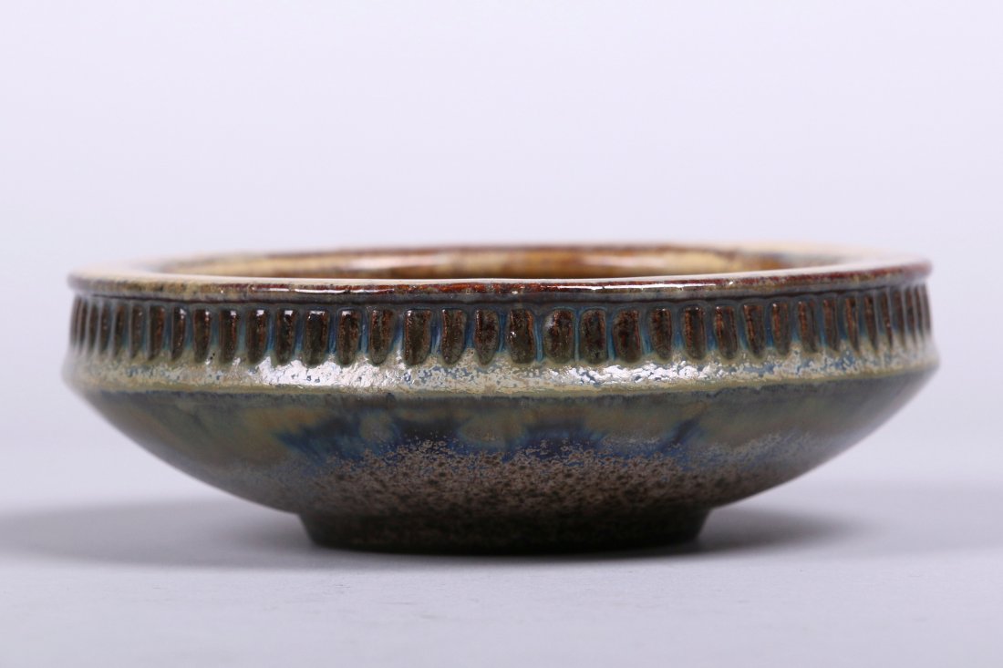 Fulper Small Bowl: Fulper Pottery small bowl with tan and brown hi-glaze and flambé underglaze. Rectangular inkstamp mark. 6 3/8"d x 2"h.