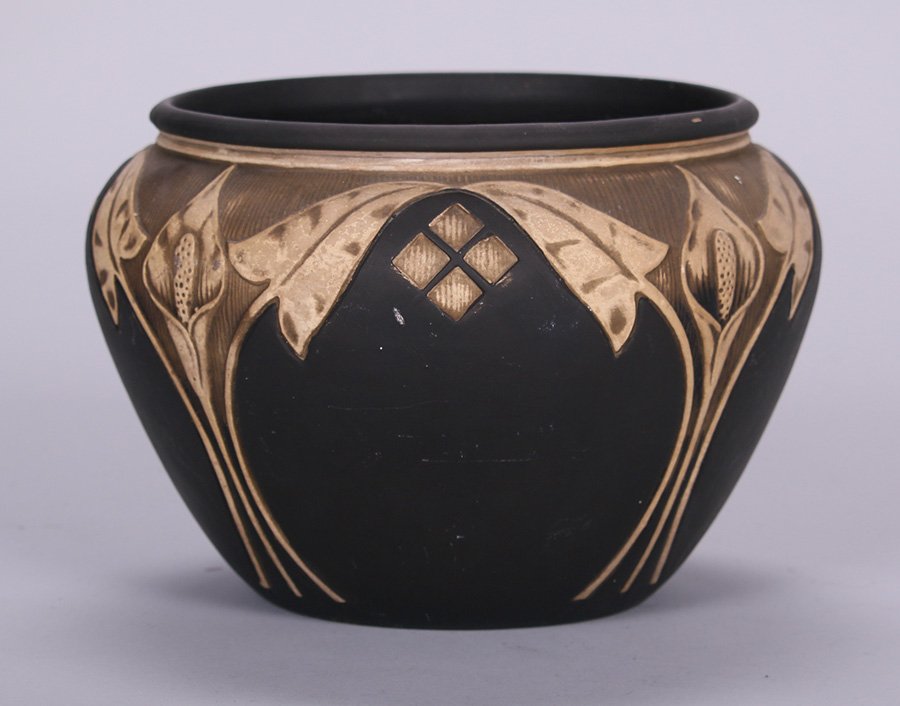 Weller Burntwood Jardiniere: Weller Burntwood Jardiniere with stylized call lily design. Unsigned. 10"d x 7.25"h. 5% of this lot will benefit The Dirk van Erp Foundation. We box and ship ourselves, to keep shipping costs low. We
