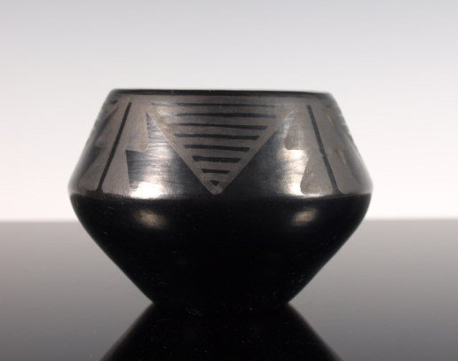 Marie & Julian Matte Black-On-Black Pottery Jar: Matte black-on-black pottery jar with geometric pattern, by Maria & Julian Martinez of San Ildefonso Pueblo c. 1925-1943. Signed "Marie & Julian." Dimensions: 3 & 1/8 in. tall x 4 & 5/8 in. diameter.