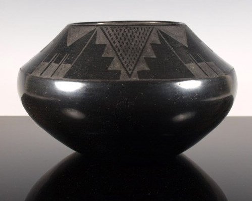 Exceptional Black-On-Black Pottery Jar by Maria: Large San Ildefonso matte black-on-black jar by Maria Martinez, a superb example of her early work, c. 1920-1925. Signed "Marie." Dimensions: 5 & 5/8 in. tall x 9 & 3/4 in. diameter.