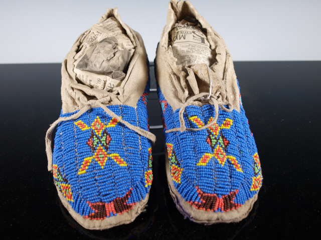 Cheyenne Beaded Moccasins: Native American Cheyenne mocs colorfully beaded with trade beads, soft leather bottoms show they were worn or danced. Blue with yellow orange green maroon design. 9.0 inches long