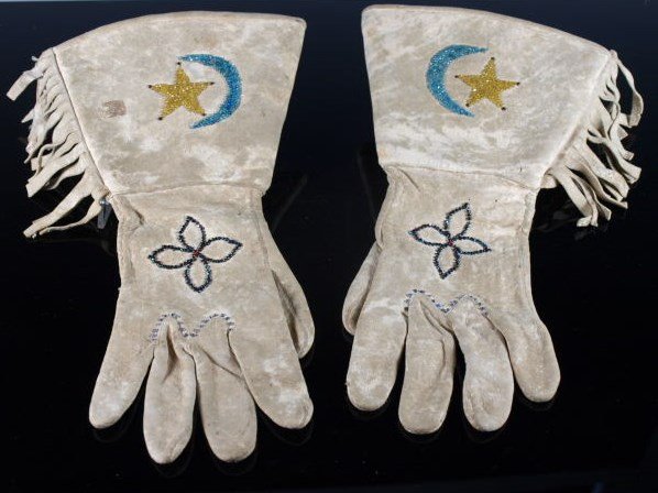 Fringed & Beaded Star & Crescent Gauntlets: Done with trade beads with the Apache star and crescent motif, has discoloration from obvious use. Dimensions: 13 in. long x 9 in. w (w/ fringe).