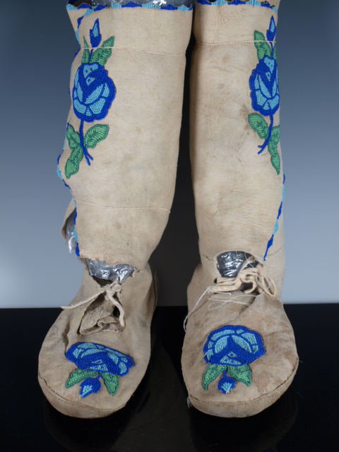 High-Top Floral Moccasins: Moccasins with soft hide leggings (high-tops) and soft soles, floral beadwork on uppers and leggings. Possibly Plateau. Native wear. Dimensions: 10 in. long x 13 in. high. For photography purposes we