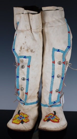 High-Top Floral Eastern beaded Moccasins: Moccasins with soft hide leggings (high-tops) and soft soles, floral beadwork on uppers and leggings. Beaded with brightly colored trade beads in floral pattern. Wear to bottom so likely danced. Dimen