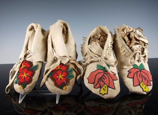 Two Pairs of Native American Eastern Beaded Moccasins: Two pairs of Eastern beaded sofe-soled moccasins, likely women's, one with fringe. Both done with trade beads, peach flowered and red flowered. Both show wear to soles.
