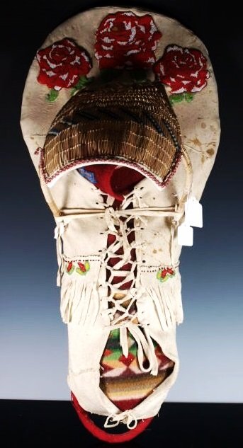 Beautiful Beaded Shoshone Baby Carrier / Cradle Board: A rare and wonderful Baby Carrier (cradle board) from the Shoshone Native American Indian people. The rare piece shows a stretched hide over a carved wood frame and a basket woven hood structure (sun 