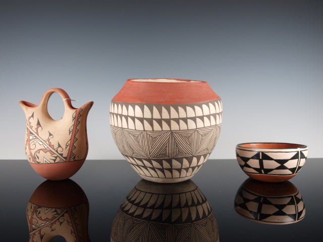 Group Of Three Pueblo Pots: Acoma, Jemez, and Santo: 1. Acoma polychrome fine-line & feather design jar, unsigned. Dimensions: 6 & 7/8 in. high x 7 & 1/2 in. diameter. 2. Jemez wedding vase, signed "Little Coyote." Dimensions: 6 in. high x 5 in. wide x 