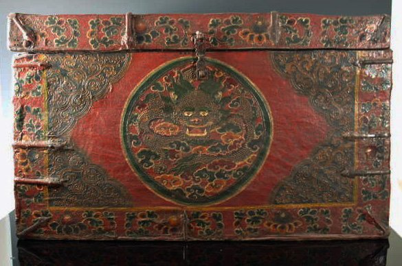 EARLY HIGHLY DECORATED TIBETAN PRIESTS CHEST: A very early 19th or late 18th Century highly decorated Tibetan Priest's storage chest. Early iron and highly decorated with motifs of dragoon, lion at top, scrolls, fur on both sides. Very rare, very
