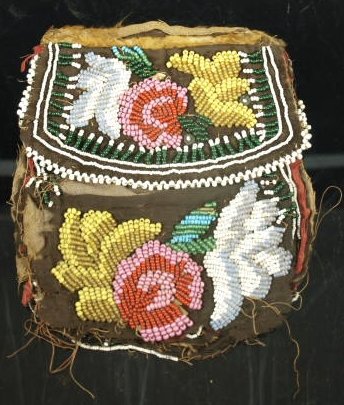 Eastern Woodlands Native American beaded pouch/purse: A good early example of Eastern Woodlands floral beadwork. Both sides are beaded, both the body of the pouch and the flaps - four beaded panels in all. The maker artfully integrated three distinct var
