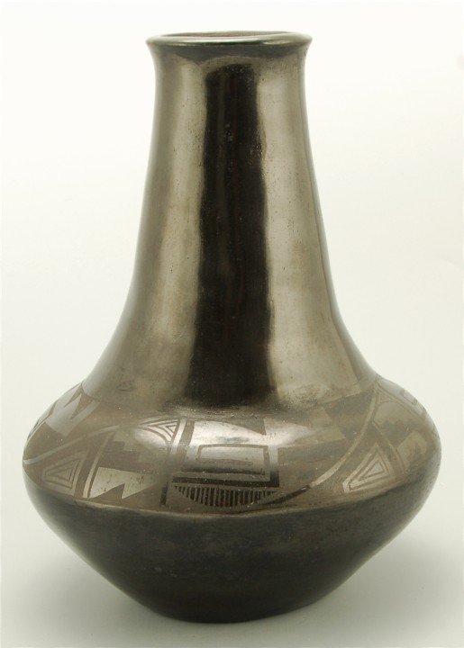 Tonita Roybal San Ildefonso Jar: Long Neck Jar, some surface damage on the shoulder, Signed Tonita. Circa 1920's. 9.5" tall x 6.5" wide. Native American