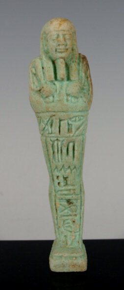 Translated Egyptian faience Ushabti: A Third Intermediate Period 1070 BC faience Ushabti. 4 1/2 inches tall, very detailed showing mummiform figure holding crook, sack of seeds and flail wearing beard and wig. Translation reads: "Oh you