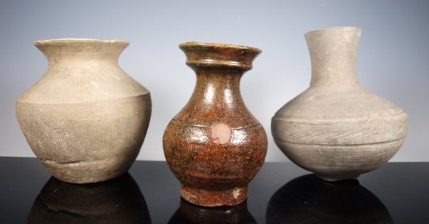 Ancient Han and Japanese ceramics: A group of three ancient vessels, first from China Warring States 475 BC 6" tall, Eastern Zhou Dynasty, cord marked. The second a glazed Han Dynasty jar missing two lugs, 5.5" tall and lastly a Japane