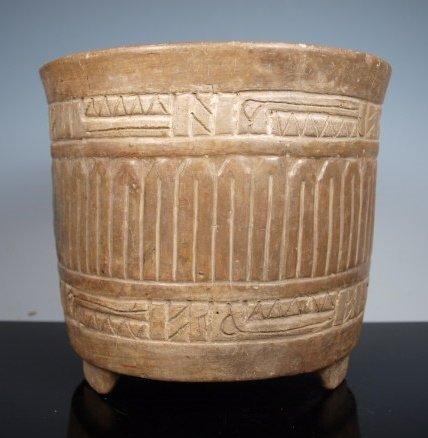 Mayan carved PetÃ©n cylinder vase: Pre-Columbian, Maya Territories, PetÃ©n, Ca 550 to 900 CE. A classic Honduras Mayan carved ceramic cylinder. Ceramic vessel carved with two bands of geometric designs, sits on tri-pod legs, polished
