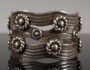 William Spratling Taxco Silver bracelet: A large William Spratling silver cuff, 2 3/4 inches at widest point, opening 1 1/2 inches. Twice marked on inside, "Spratling Silver" and the circle "Spratling, Made in Mexico" A great and large brace