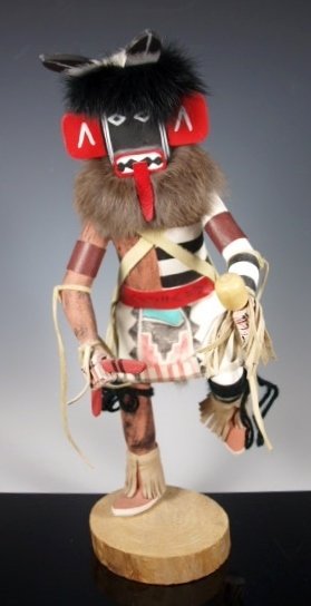 Hopi Katsina Kachina Left Hand Racer Ernest Calvin: 1970's style Kachina doll, Hopi Pueblo, Cottonwood root, with clothing applied rather than carved in. Materials applied are hide, fur, and wool. The doll appears in mid-stride. It shows carved feather