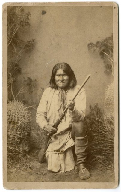 GERONIMO KNEELING WITH HIS RIFLE by A. Frank Randall: GERONIMO KNEELING WITH HIS RIFLE. This is an albumen print on a boudoir mount of this famous photograph by A. Frank Randall. It has Randall's copyright label on the verso, over-stamped in red Copyrigh
