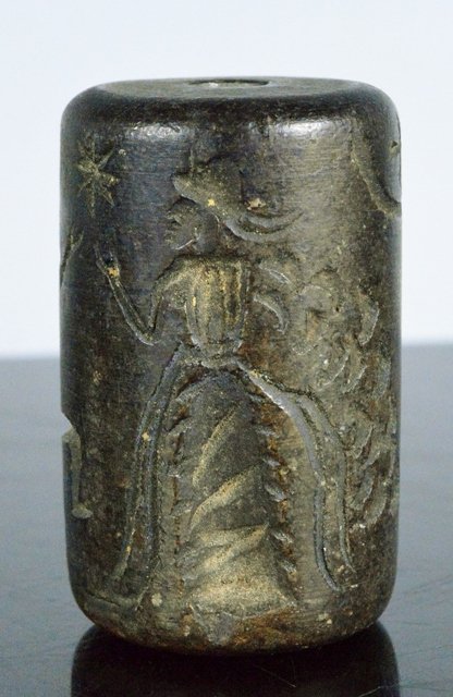 Important Ancient Mesopotamian Steatite Cylinder Seal: "3000-2500 BC. An unusually large steatite cylinder seal, depicting female, jumping man and man with spear, above stars and the crecent and cross symbol for Baal. Very large example 4.3 cm. long and 2
