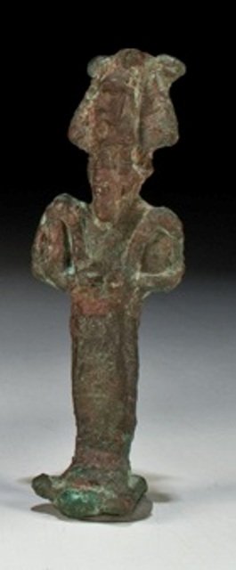 Ancient Egyptian Bronze Osiris Figure: Egyptian - Late Period Period: Late period, ca. 700-30 B.C. Size: 2 7/8 inches tall Description: A bronze figure of Osiris wearing beard and atef crown with double maat feathers. Holds flail and scept