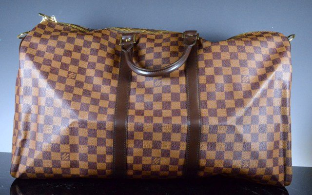 Louis Vuitton KEEPALL BANDOULIÈRE 55: An icon since the appearance in 1930, the Keepall embodies the spirit of modern travel. Light, supple and always ready for immediate departure, the bag lives up to its name: those adept at the art of