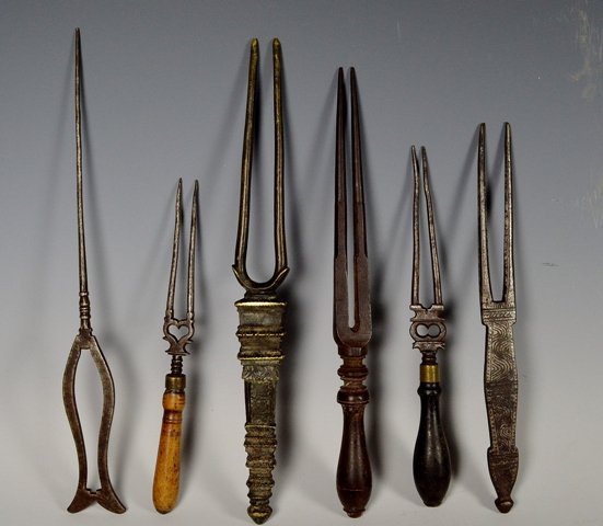 Early India feast forks: A group of six early India feast forks, one wood the rest metal. Elaborately decorated one with sand script.