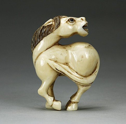 ANTIQUE JAPANESE NETSUKE OF A HORSE: Standing with its head turned to look behind it. Stained details. Signature on the bottom hoof. H: 1 7/8 in. Check your local wildlife laws to insure Federal compliance with shipping. These are pre-ba