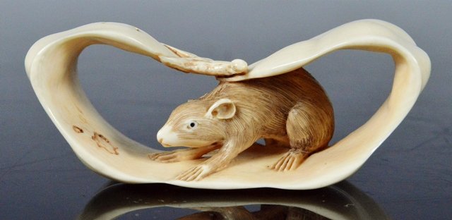 Early signed Japanese Netsuke rat on leaf: Very detailed and nicely carved. Early patina and signed on bottom. Small rat inside of leaf. : 2 inches long. Check your local wildlife laws to insure Federal compliance with shipping. These are pre-