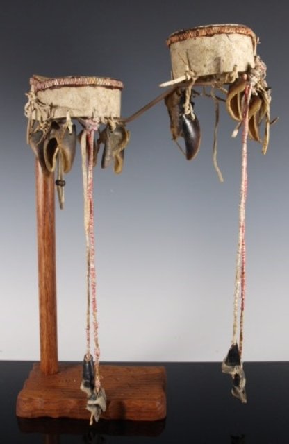 Early Sioux Rawhide Armbands, Deer Dewclaws: Old and well-used pair of Sioux armbands, of rawhide edged at the top with a single band of red-dyed plaited quillwork, faded over time. Dewclaws hang suspended from the lower edge, secured by short h