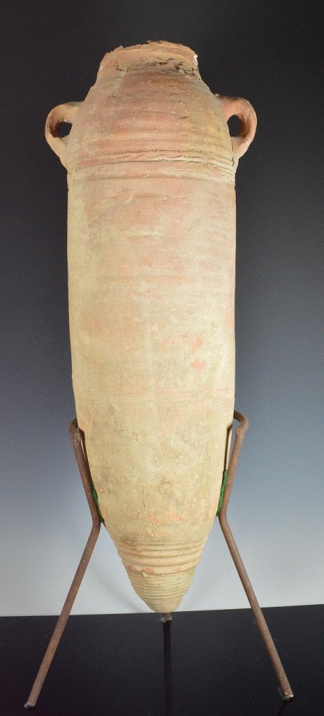 Large Ancient Roman transport wine amphora: A large tapered base ceramic Roman (200 BC - 300 AD) ships transport amphora. A slender terracotta vessel with twin handles, pointed base, original clay top / stopper partially still intact. 26 inches