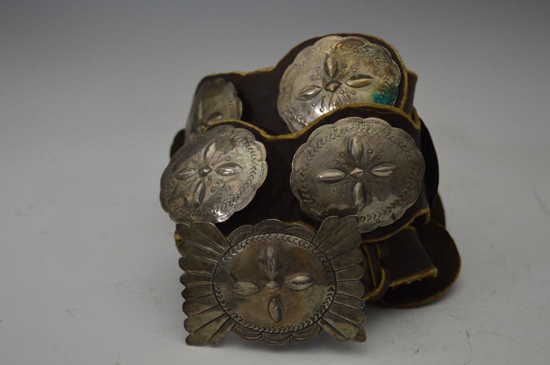 Navajo Silver Concho Belt: Navajo Silver Concho Belt, composed of 9 conchos plus matching buckle, stamps and repousÃ©. FROM THE ESTATE OF JOHN KOEHLER. Mr. Koehler, an avid collector, had, at one time, purchased a defunct "In