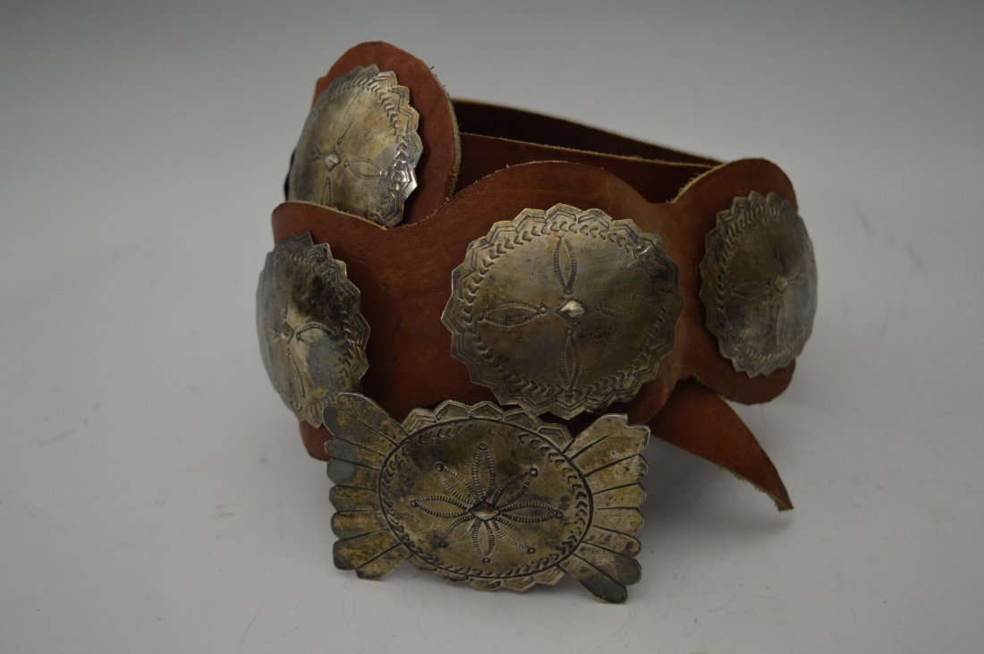Navajo Silver Concho Belt: Navajo Silver Concho Belt, composed of 9 conchos plus matching buckle, stamps and repousÃ©. FROM THE ESTATE OF JOHN KOEHLER. Mr. Koehler, an avid collector, had, at one time, purchased a defunct "In