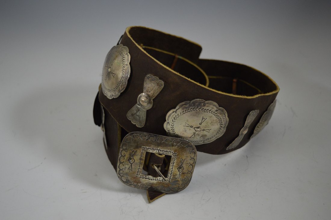 Navajo Silver Concho Belt: Navajo Silver Concho Belt, composed of 7 conchos and 8 butterflies, plus buckle of the period, stamps and repousÃ©. FROM THE ESTATE OF JOHN KOEHLER. Mr. Koehler, an avid collector, had, at one time,