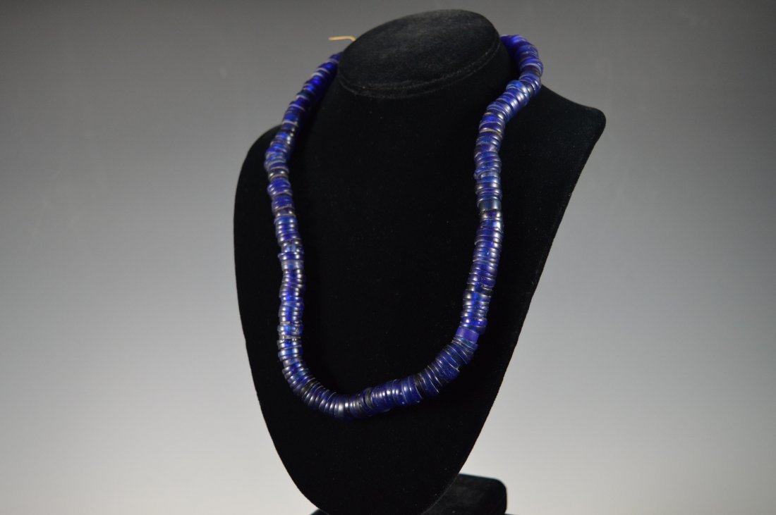 Santo Domingo Glass Bead Necklace: Discoidal bead necklace, cobalt blue beads strung on tightly twisted straw. Santo Domingo Pueblo. FROM THE ESTATE OF JOHN KOEHLER. Mr. Koehler, an avid collector, had, at one time, purchased a defunct