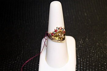 Lady's 14K Yellow Gold Alexandrite/ Cat's eye/ Orange: This Lady's 14K gold alexandrite/ cat's eye/ orange sapphire ring is comprised of 4 prongs set trillian cut 1 alexandrite surrounded by 5 round brilliant cut orange sapphires and 4 cat's eyes. Total e