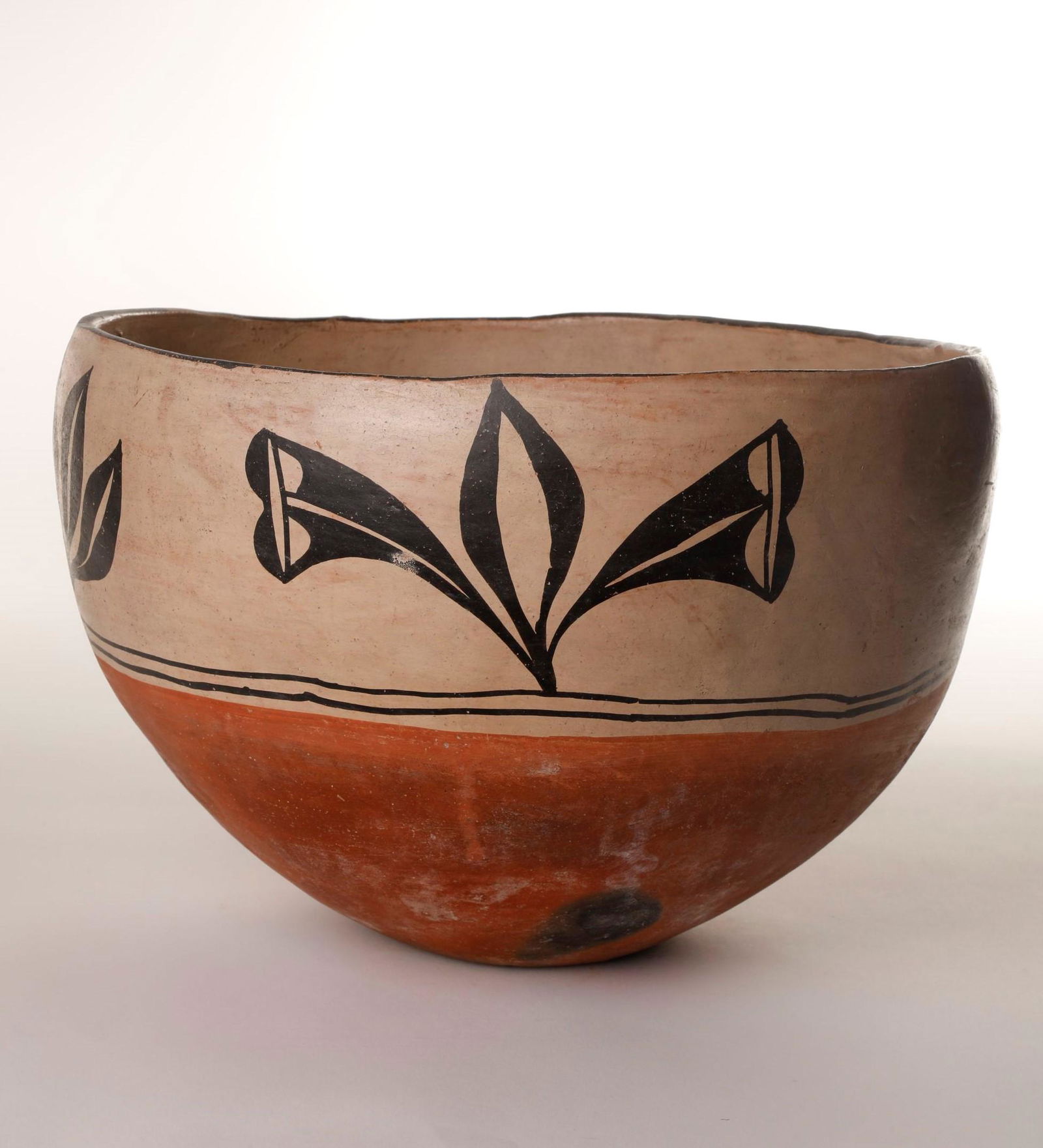 Santo Domingo, Polychrome Dough Bowl, ca. 1890: Santo Domingo Polychrome Dough Bowl ca. 1890 clay, pigment height 10 3/4 x diameter 14 3/4 in. Large deep wide mouth dough bowl with black painted foliate design on buff upper body, red slipped base w