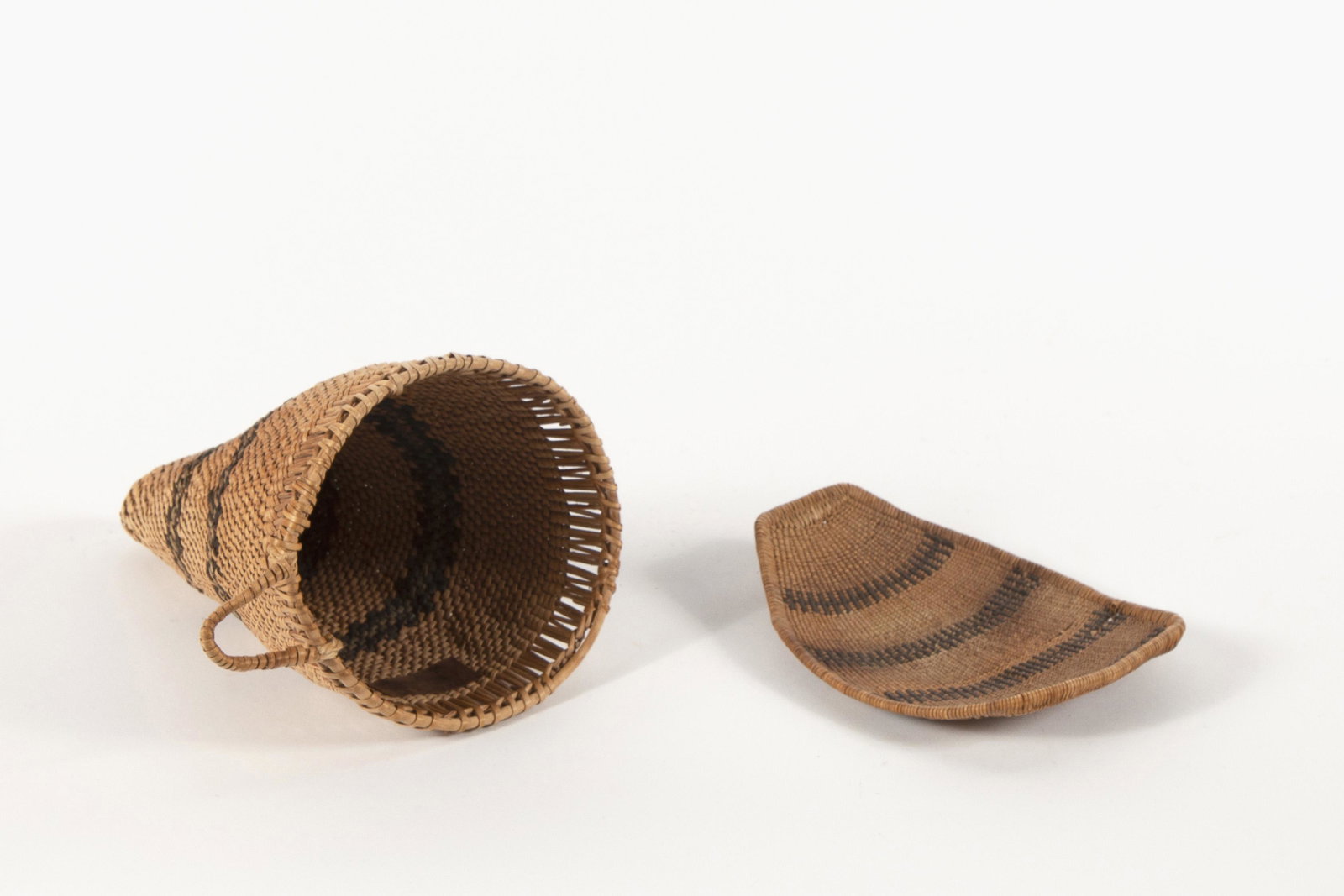 Paiute, Group of Two Baskets: Paiute Group of Two Baskets Conical Burden Basket height 8 x diameter 5 ½ in Winnowing Tray length 6 x width 5 in **Proceeds from the sale of this work benefit a