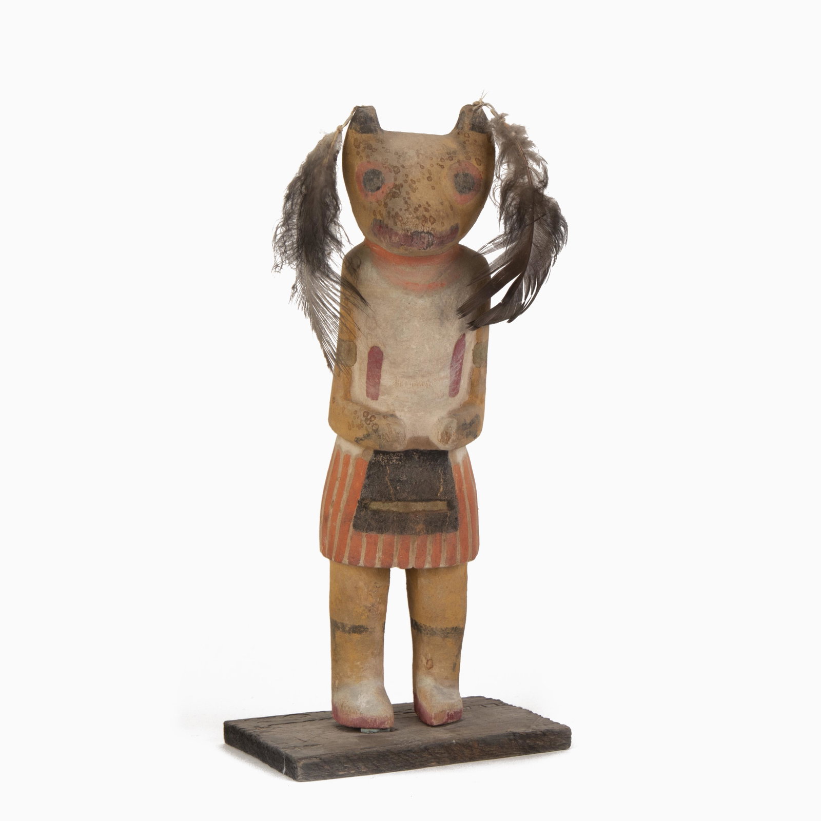 A Hopi Wolf Kachina, ca. 1920: Hopi Wolf Kachina, ca. 1920 cottonwood, pigment, feathers trading post label to underside: Wolf / Kachina / Hopi / Kweo / #31 9 x 4 x 4 in. (22.86 x 10.16 x 10.16 cm.) **Proceeds from the sale of this