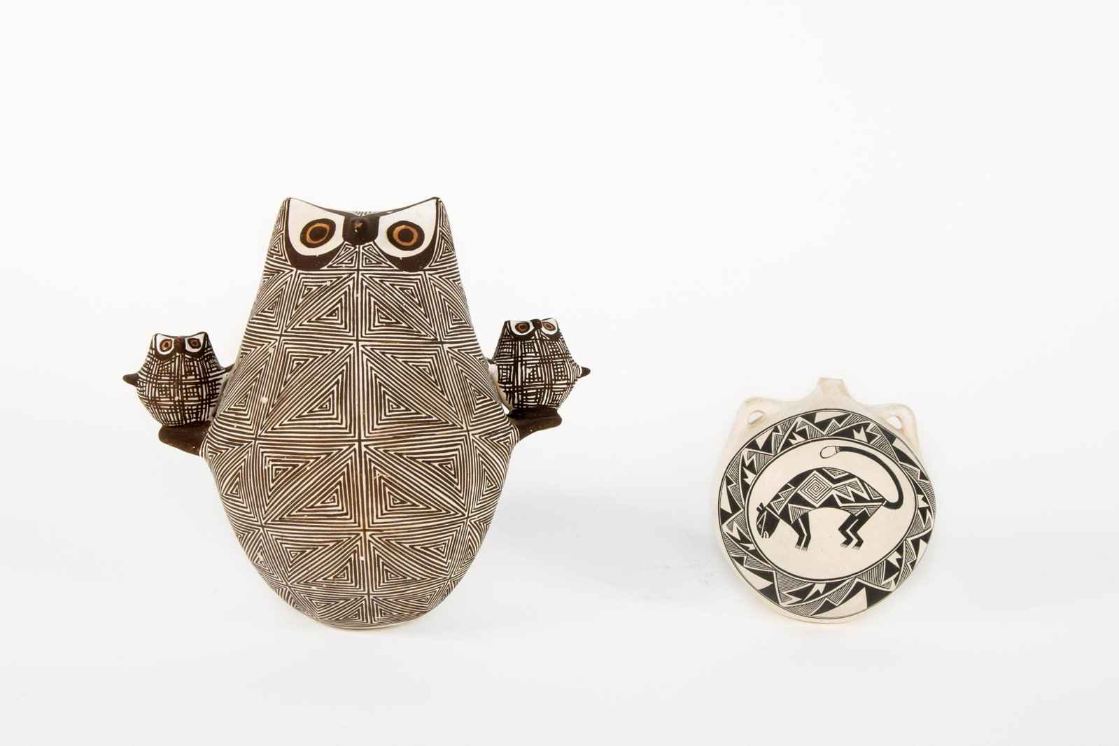 Two Acoma Pottery Vessels: Two Acoma Pottery Vessels C. Maurus Chino(Acoma, b. 1954)'Mountain Lion and Rain Storm' Handled Vessel, 1987inscribed underside: C. Maurus Chino / "MOUNTAIN LION AND / RAIN STORM" / © 19874 x 3 1/2 x