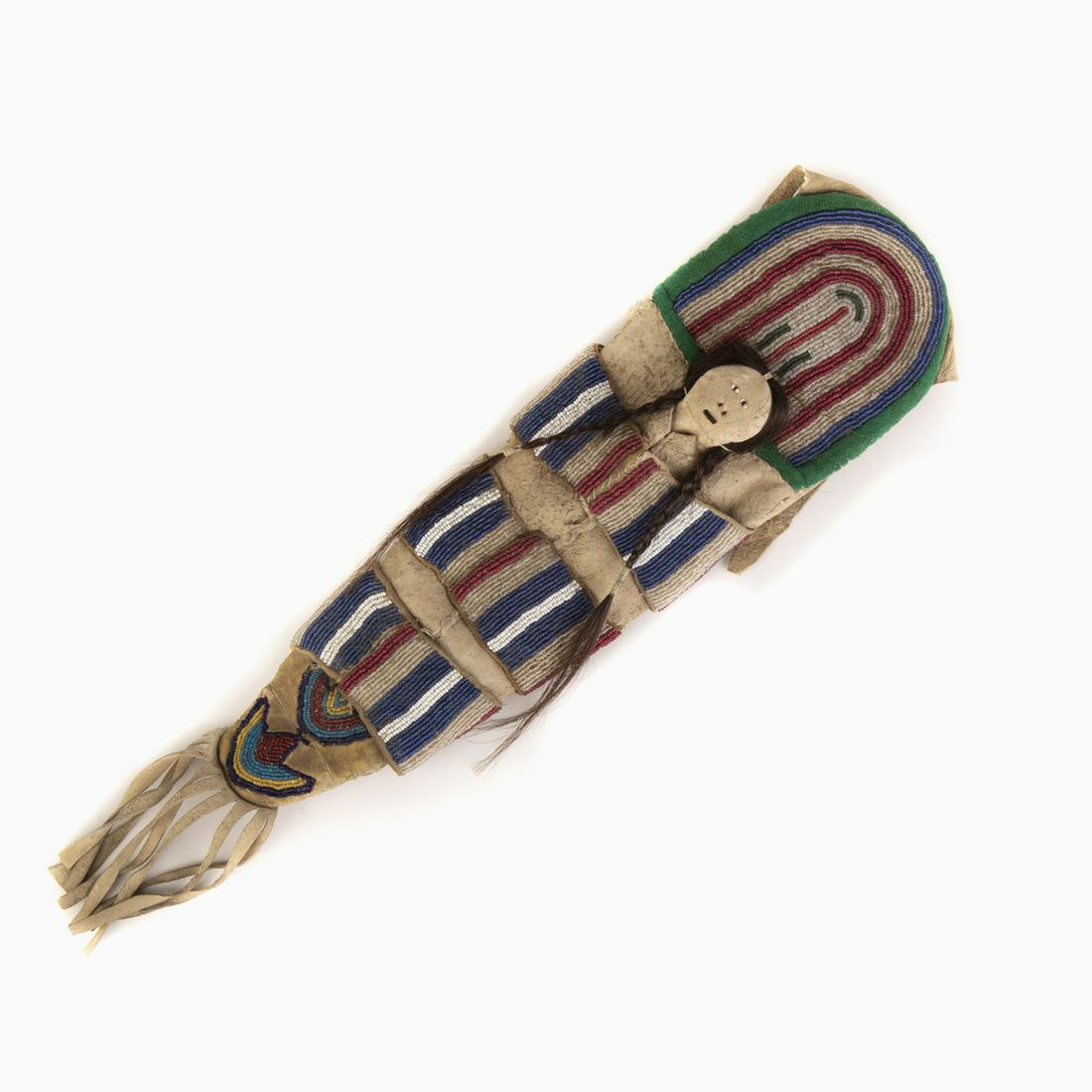 A Crow Beaded Miniature Cradleboard, ca. 1910-1920: Crow Beaded Miniature Cradleboard, ca. 1910-1920 having dark blue, light blue, indigo, yellow-green, red, translucent glass seed beads hide, sinew, hair 22 1/2 x 4 1/2 in. (57.15 x 11.43 x 1.91 cm.) P