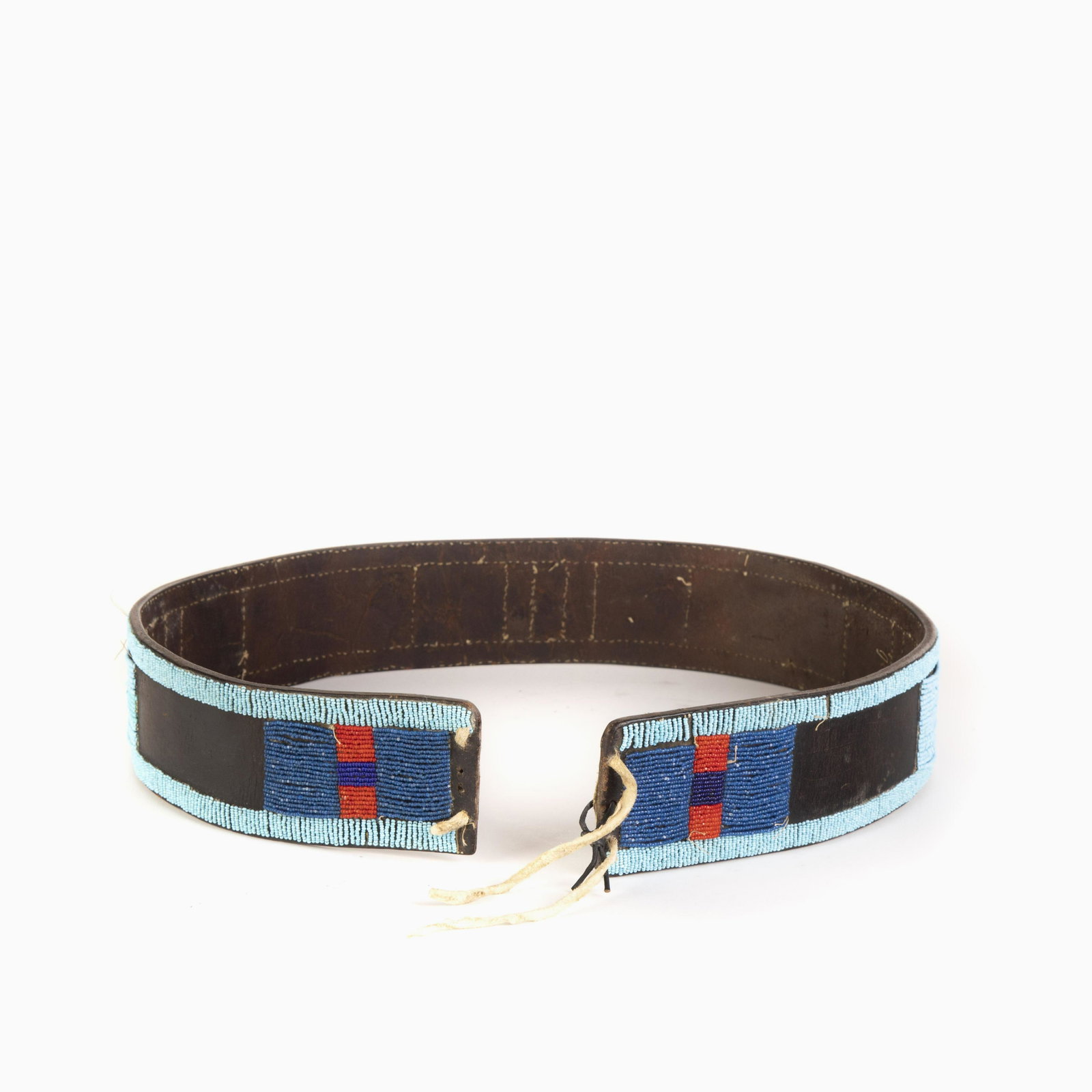 A Blackfoot Beaded Panel Belt, ca. 1930: Blackfoot Beaded Panel Belt, ca. 1930 having light blue, navy blue, red and black glass seed beads 2 1/2 x 36 1/4 in. (6.35 x 92.08 cm.)