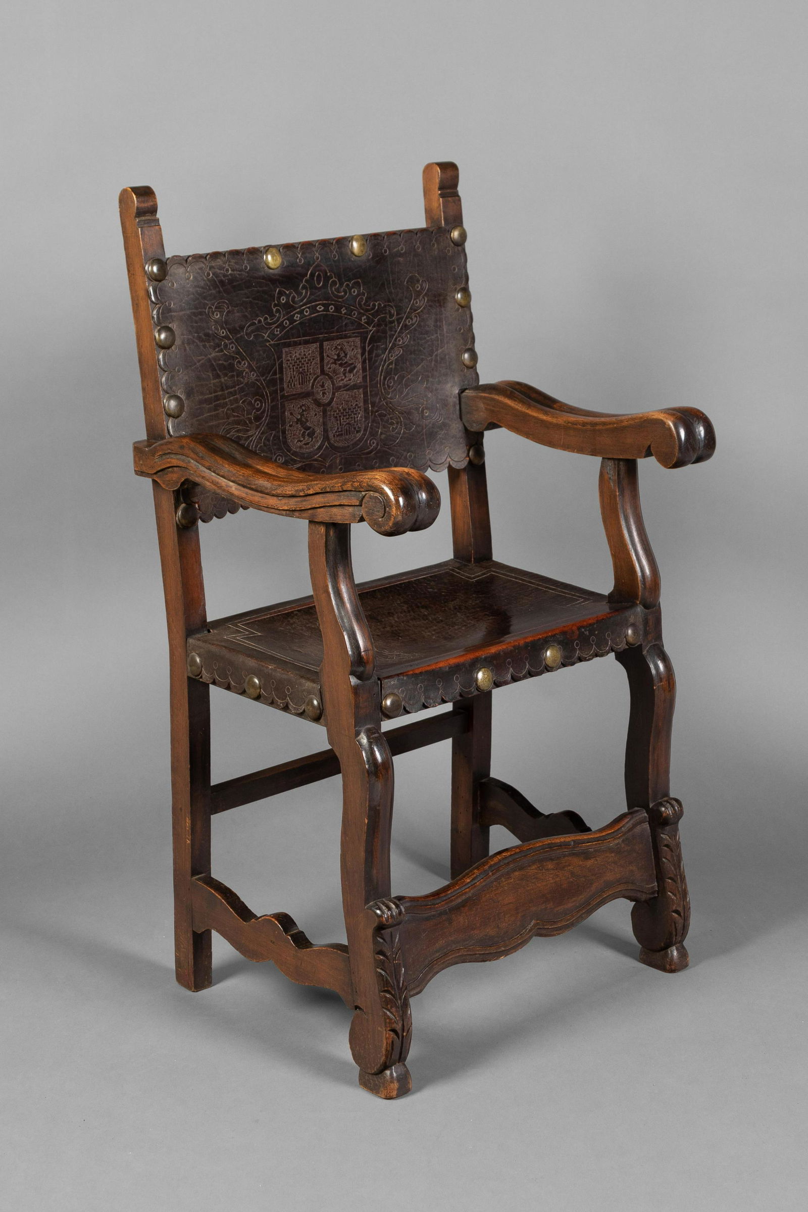 Spanish Colonial, Upper Peru, Sillon de Frailero Chair, 17th-18th Century: Spanish Colonial, Upper Peru, Andes Region Sillon de Frailero Chair, 17th-18th Centurya hand-carved alliso wood "Friar's Chair," with tooled leather seats41 3/4 x 22 3/4 x 20 in. (106.05 x 5
