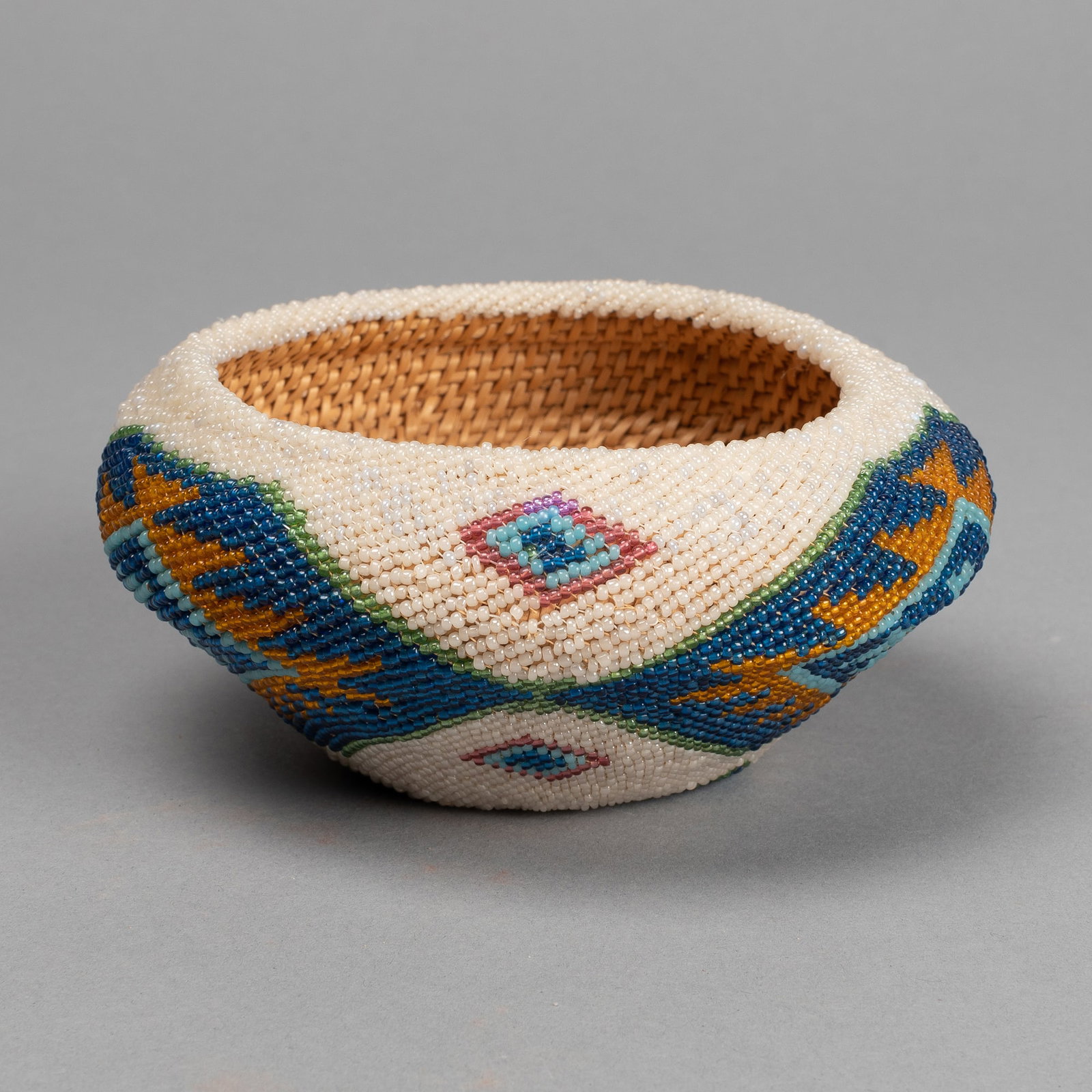 Washoe, Beaded Basketry Bowl, ca. 1920: Washoe Beaded Basketry Bowl, ca. 1920 woven natural reeds and beads Height: 2 5/8 in. x Diameter: 5 1/2 in. (6.7 cm. x 14 cm.) Private Collection, Arizona