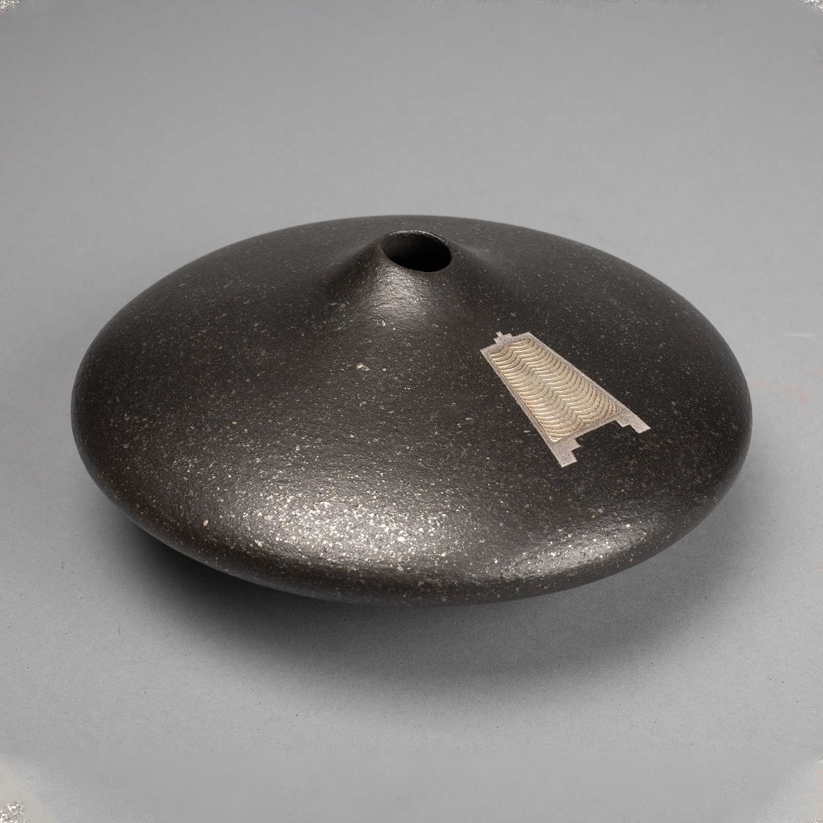 Preston Duwyenie [Lomaiquilvaa], Micaceous Jar with Silver Inset Cuttlefish: Preston Duwyenie [Lomaiquilvaa] (Hopi, b. 1951) Micaceous Jar with Silver Inset Cuttlefish fired clay, silver inscribed: [kokopelli cipher] Height: 3 1/4 x Diameter: 8 in. (8.3 x 20.3 cm.) Private Col